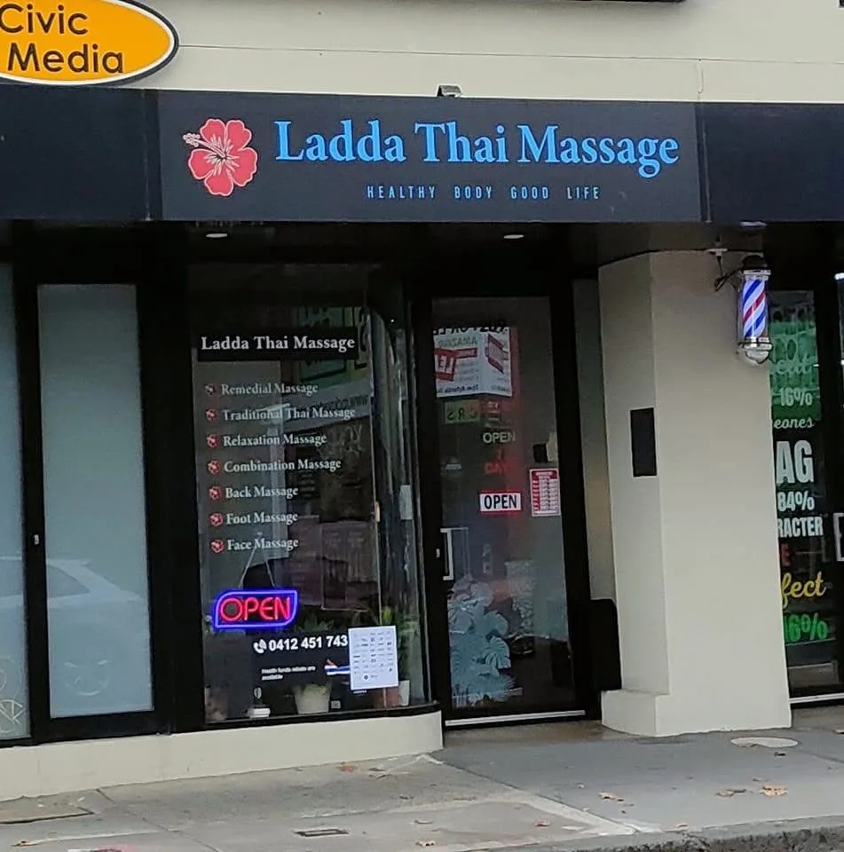 Ladda Thai Massage shopfront on Johnston St, Collingwood — OPEN neon, HEALTHY BODY GOOD LIFE signage
